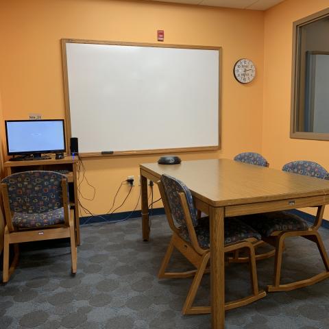 Study Room B table, chairs, computer, and white board.